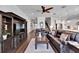 Open-concept living room with hardwood floors and built-in shelving at 1308 Alhambra Dr, Apollo Beach, FL 33572
