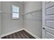 Large walk-in closet with window and wood floors at 1308 Alhambra Dr, Apollo Beach, FL 33572