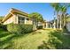 Landscaped backyard with lush lawn and manicured hedges at 14608 Mirasol Manor Ct, Tampa, FL 33626