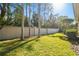 Landscaped backyard with lush lawn and tall trees, offering privacy at 14608 Mirasol Manor Ct, Tampa, FL 33626