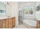 Elegant bathroom with corner soaking tub, shower, and double vanity at 14608 Mirasol Manor Ct, Tampa, FL 33626