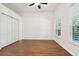 Bedroom with hardwood floors, double door closet and ceiling fan at 14608 Mirasol Manor Ct, Tampa, FL 33626