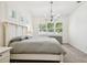 Spacious bedroom with a large bed, window with shutters, and carpeted floor at 14608 Mirasol Manor Ct, Tampa, FL 33626