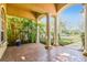 Covered porch with brick flooring and lush landscaping at 14608 Mirasol Manor Ct, Tampa, FL 33626