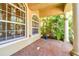 Covered porch with brick flooring and arched windows at 14608 Mirasol Manor Ct, Tampa, FL 33626