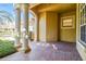 Covered entry with brick flooring and white columns at 14608 Mirasol Manor Ct, Tampa, FL 33626