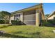 Exterior view showcasing the home's screened patio and landscaping at 14608 Mirasol Manor Ct, Tampa, FL 33626