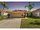 Beautiful two-story home with a large garage and lush landscaping at 14608 Mirasol Manor Ct, Tampa, FL 33626
