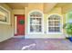 Red front door with a wreath and sidelights at 14608 Mirasol Manor Ct, Tampa, FL 33626