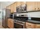 Updated kitchen with stainless steel appliances and granite countertops at 14608 Mirasol Manor Ct, Tampa, FL 33626