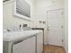 Laundry room with washer, dryer, sink, and extra shelving at 14608 Mirasol Manor Ct, Tampa, FL 33626