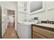 Convenient laundry room, washer, dryer, and built-in cabinets at 14608 Mirasol Manor Ct, Tampa, FL 33626