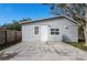 Gray house with a large backyard, wooden fence, and a concrete patio at 1575 S Martin Luther King Jr Ave, Clearwater, FL 33756