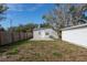 Gray house with a large backyard, wooden fence, and a concrete patio at 1575 S Martin Luther King Jr Ave, Clearwater, FL 33756