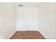 Simple bedroom with wood floors and a door at 1575 S Martin Luther King Jr Ave, Clearwater, FL 33756