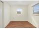 Simple bedroom with hardwood floors and neutral walls at 1575 S Martin Luther King Jr Ave, Clearwater, FL 33756