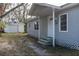 Gray house with a detached garage, and a small front yard at 1575 S Martin Luther King Jr Ave, Clearwater, FL 33756