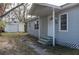 Gray house with a detached garage, and a small front yard at 1575 S Martin Luther King Jr Ave, Clearwater, FL 33756