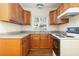 Small kitchen with wood cabinets and granite counters at 1575 S Martin Luther King Jr Ave, Clearwater, FL 33756