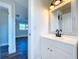 Clean bathroom with white vanity, black fixtures, and a framed mirror at 1709 Marilyn Ave, Bradenton, FL 34207