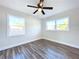 Well-lit bedroom with two windows and wood-look floors at 1709 Marilyn Ave, Bradenton, FL 34207
