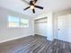 Well-lit bedroom featuring wood-look floors, a ceiling fan, and ample closet space at 1709 Marilyn Ave, Bradenton, FL 34207