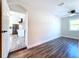 Charming bedroom with kitchen view and wood-look floors at 1709 Marilyn Ave, Bradenton, FL 34207
