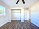 Bright bedroom with wood-look floors, ceiling fan, and spacious closet at 1709 Marilyn Ave, Bradenton, FL 34207