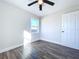 Bright bedroom with wood-look floors and ceiling fan at 1709 Marilyn Ave, Bradenton, FL 34207