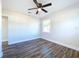 Spacious bedroom with wood-look floors, ceiling fan, and a window offering natural light at 1709 Marilyn Ave, Bradenton, FL 34207