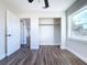 Well-lit bedroom with wood-look floors, ceiling fan and closet at 1709 Marilyn Ave, Bradenton, FL 34207