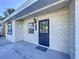 Modern front entrance with a black door and a light-colored brick exterior at 1709 Marilyn Ave, Bradenton, FL 34207