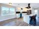 Updated kitchen with white cabinets, stainless steel appliances, and island at 1709 Marilyn Ave, Bradenton, FL 34207