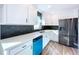 Modern kitchen with white cabinets and blue dishwasher at 1709 Marilyn Ave, Bradenton, FL 34207