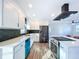 Modern kitchen with white cabinets, stainless steel appliances, and quartz countertops at 1709 Marilyn Ave, Bradenton, FL 34207