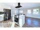 Modern kitchen with island, stainless steel appliances, and hardwood floors at 1709 Marilyn Ave, Bradenton, FL 34207