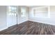 Bright living room with hardwood floors and access to other rooms at 1709 Marilyn Ave, Bradenton, FL 34207