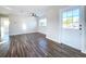 Spacious living area featuring hardwood floors and a ceiling fan at 1709 Marilyn Ave, Bradenton, FL 34207