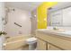 Bathroom with shower/tub combo and yellow walls at 1812 Mariner Dr # 137, Tarpon Springs, FL 34689