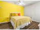 Bedroom with yellow accent wall and ceiling fan at 1812 Mariner Dr # 137, Tarpon Springs, FL 34689