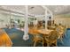 Bright community room with tables, chairs, and a library area at 1812 Mariner Dr # 137, Tarpon Springs, FL 34689