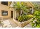 Ground level entrance with lush tropical landscaping at 1812 Mariner Dr # 137, Tarpon Springs, FL 34689