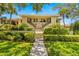 Building exterior with manicured landscaping and walkway at 1812 Mariner Dr # 137, Tarpon Springs, FL 34689