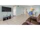 Living room with tile floors, recliner, and view to dining area at 1812 Mariner Dr # 137, Tarpon Springs, FL 34689