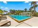 Relaxing community pool area with lounge chairs and a shaded pergola at 1812 Mariner Dr # 137, Tarpon Springs, FL 34689