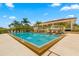 Community pool with lounge chairs, offering a relaxing waterfront view at 1812 Mariner Dr # 137, Tarpon Springs, FL 34689