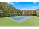 Well-maintained tennis court, surrounded by lush landscaping, in a condo community at 1812 Mariner Dr # 137, Tarpon Springs, FL 34689