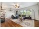 Living room with hardwood floors, leather couch, and large windows at 1926 Burlington N Ave, St Petersburg, FL 33713