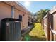 AC unit and grassy backyard with wooden fence at 1939 Sandra Dr, Clearwater, FL 33764