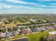 Aerial view of community, showcasing homes near a lake at 20716 Amanda Oak Ct, Land O Lakes, FL 34638
